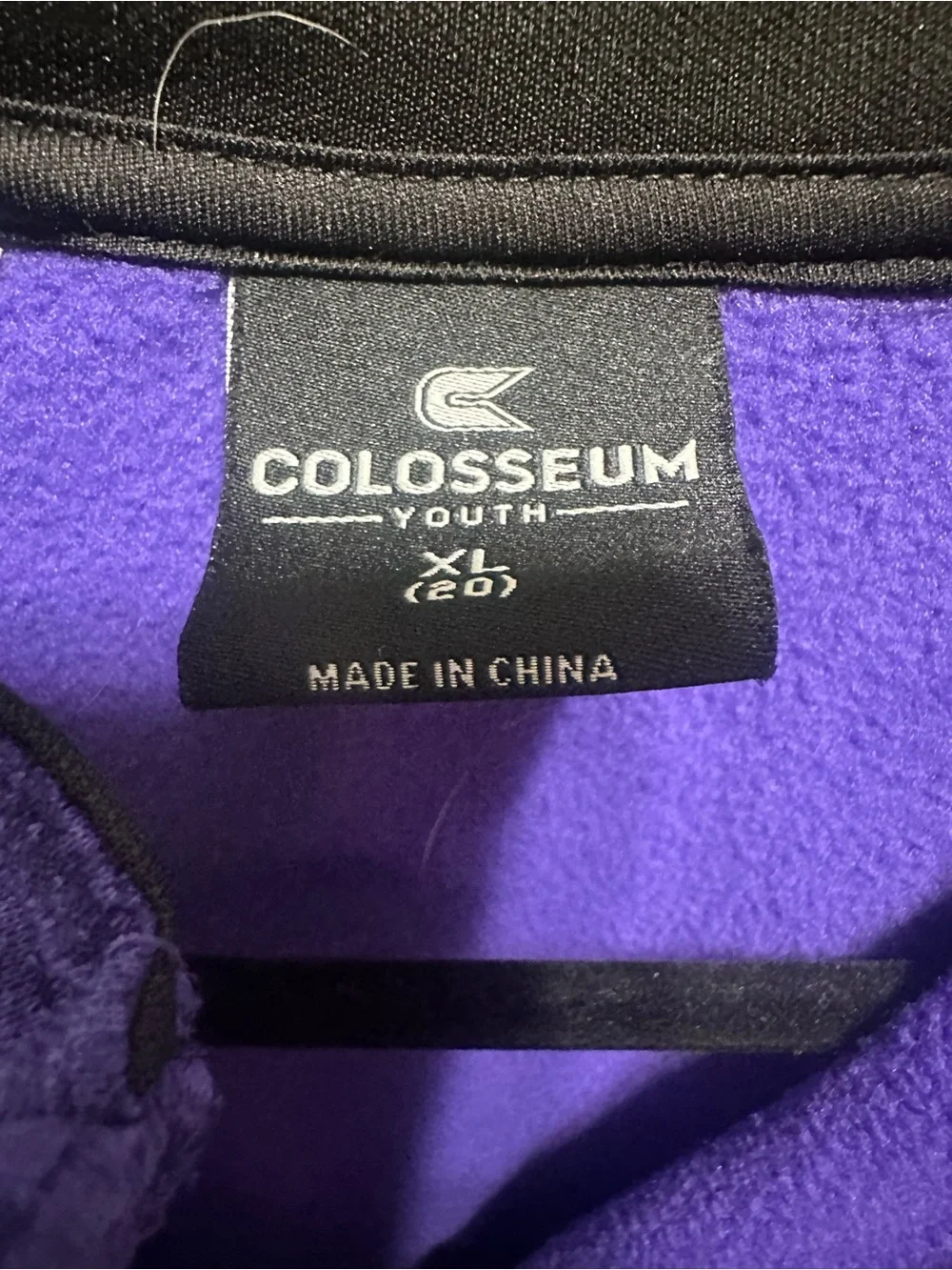 Two K-State Colosseum Youth XL quarter zips.
